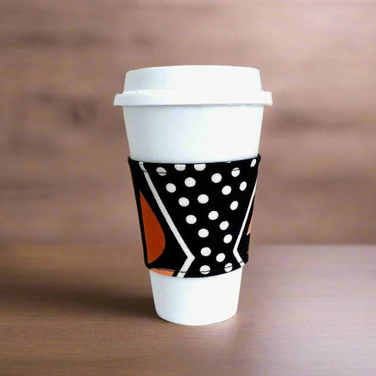 Handmade Cup Sleeve: Ethnic fabric design in black, orange, and white. This vibrant and stylish mud cloth inspiredc up sleeve adds a touch of cultural sophistication to your drinkware.