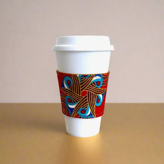 Handmade Cup Sleeve: Ethnic, fabric design with red, blue, brown, white, and gold patterns. This unique and stylish cup sleeve is perfect for adding a touch of elegance and cultural flair to your beverage.