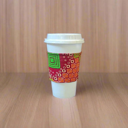 Handmade Cup Sleeve: Ethnic fabric design in red, green, cream, and yellow. This eye-catching and culturally inspired cup sleeve adds vibrant style to your drinkware.