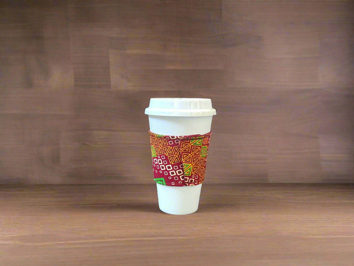 Handmade Cup Sleeve: Ethnic fabric design in red, green, cream, and yellow. This eye-catching and culturally inspired cup sleeve adds vibrant style to your drinkware.