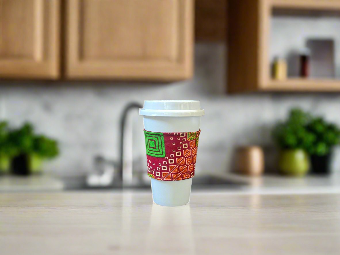 Handmade Cup Sleeve: Ethnic fabric design in red, green, cream, and yellow. This eye-catching and culturally inspired cup sleeve adds vibrant style to your drinkware.