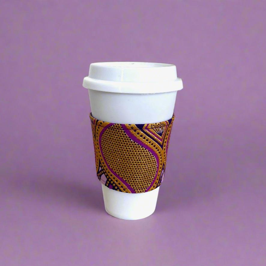 Handmade Cup Sleeve: Ethnic, fabric design with dark purple, lavender, and gold patterns. This unique and stylish cup sleeve is perfect for adding a touch of elegance and cultural flair to your beverage.