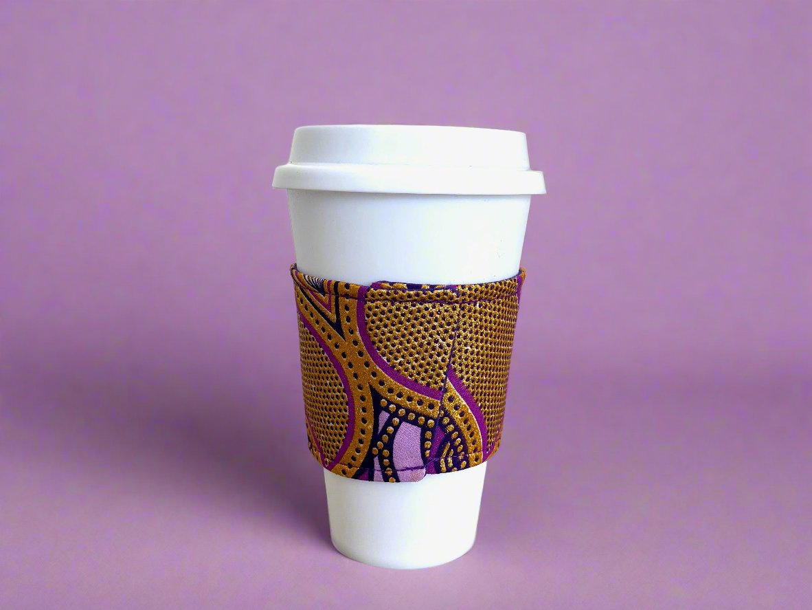 Handmade Cup Sleeve: Ethnic, fabric design with dark purple, lavender, and gold patterns. This unique and stylish cup sleeve is perfect for adding a touch of elegance and cultural flair to your beverage.