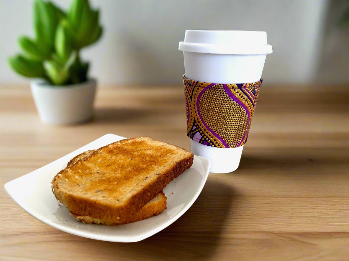 Handmade Cup Sleeve: Ethnic, fabric design with dark purple, lavender, and gold patterns. This unique and stylish cup sleeve is perfect for adding a touch of elegance and cultural flair to your beverage.