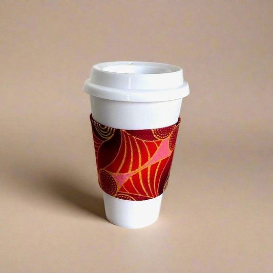 Handmade Cup Sleeve: Ethnic, fabric design with maroon, pink, red and gold patterns. This unique and stylish cup sleeve is perfect for adding a touch of elegance and cultural flair to your beverage.